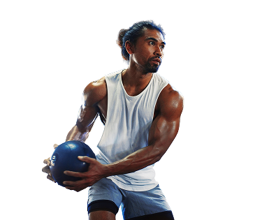 Man holding a medicine ball against a white background